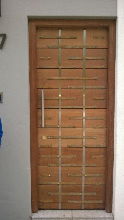 Wooden door with metal strips